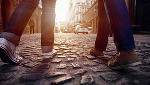 Walking feet on a cobblestone street.