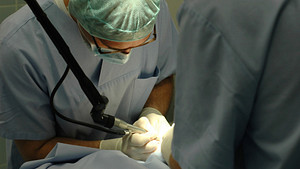 Doctors performing surgery in an operating room
